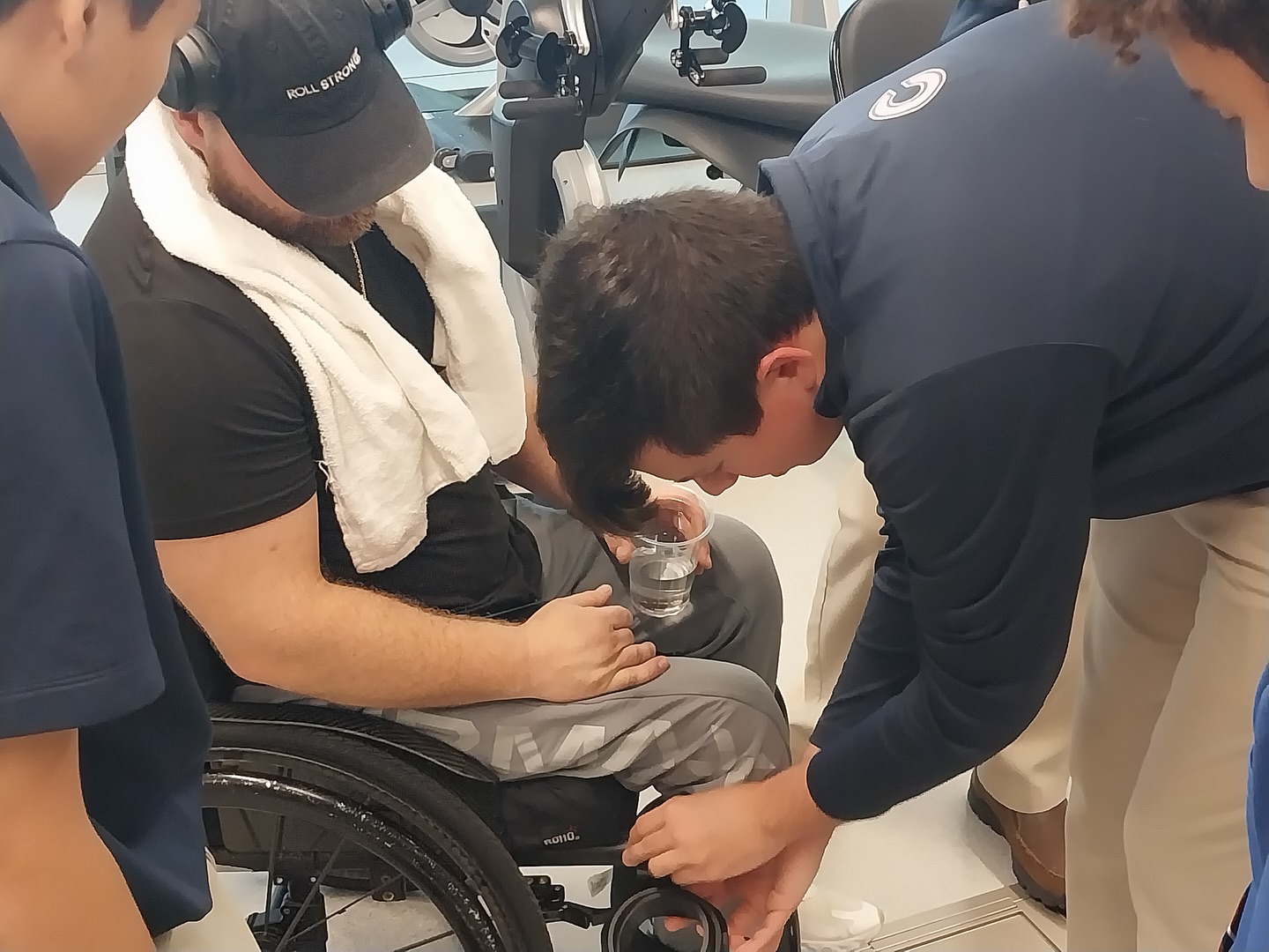 Students providing hands-on assistance with an assistive device